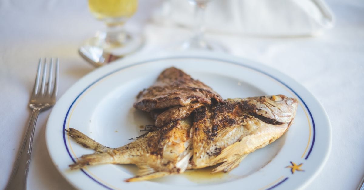 Grilled fish and Istrian olive oil on a konoba table